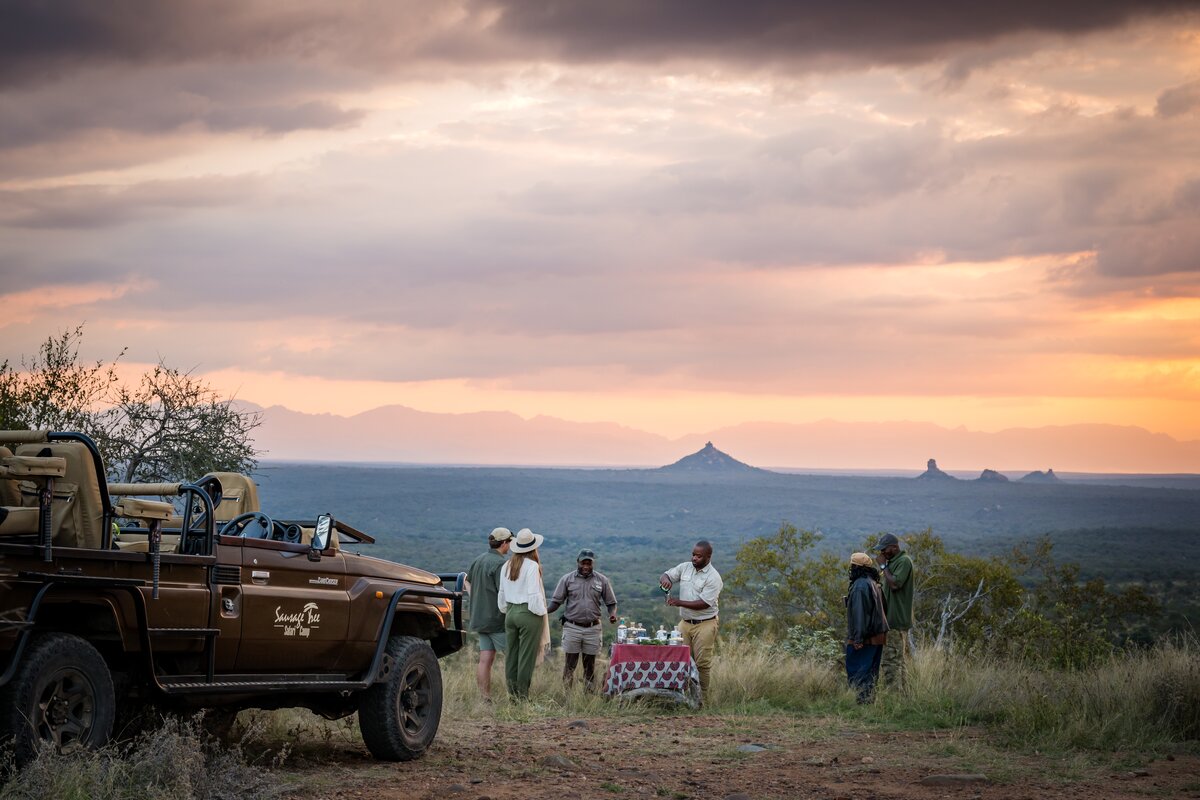 Guests sharing a sundowner moment with the Sausage Tree host team