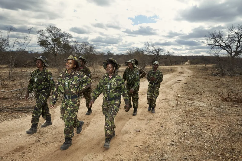 Members of the Black Mamba anti-poaching unit walking a patrol road in formation