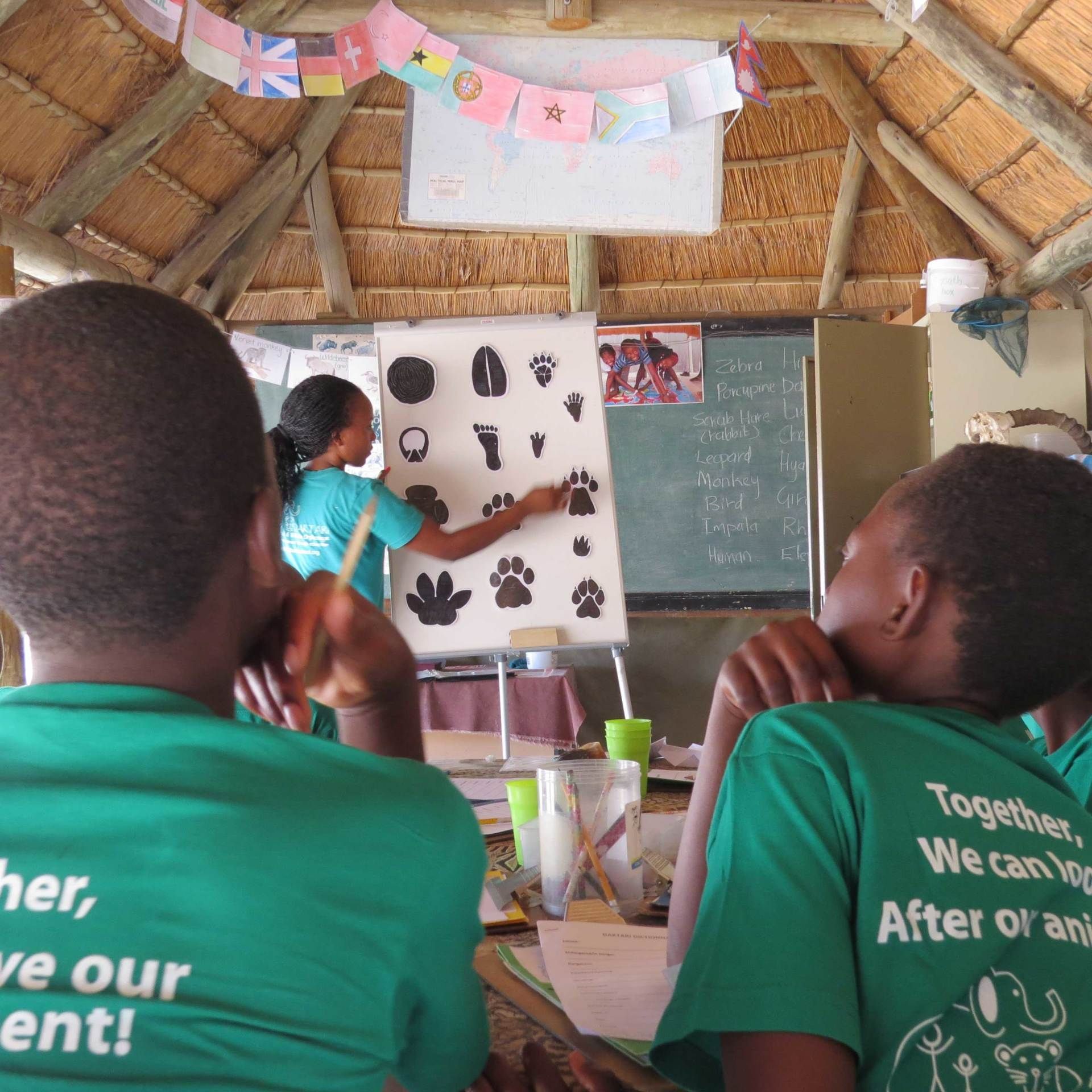 Children learning to read animal tracks at Daktari Bush School